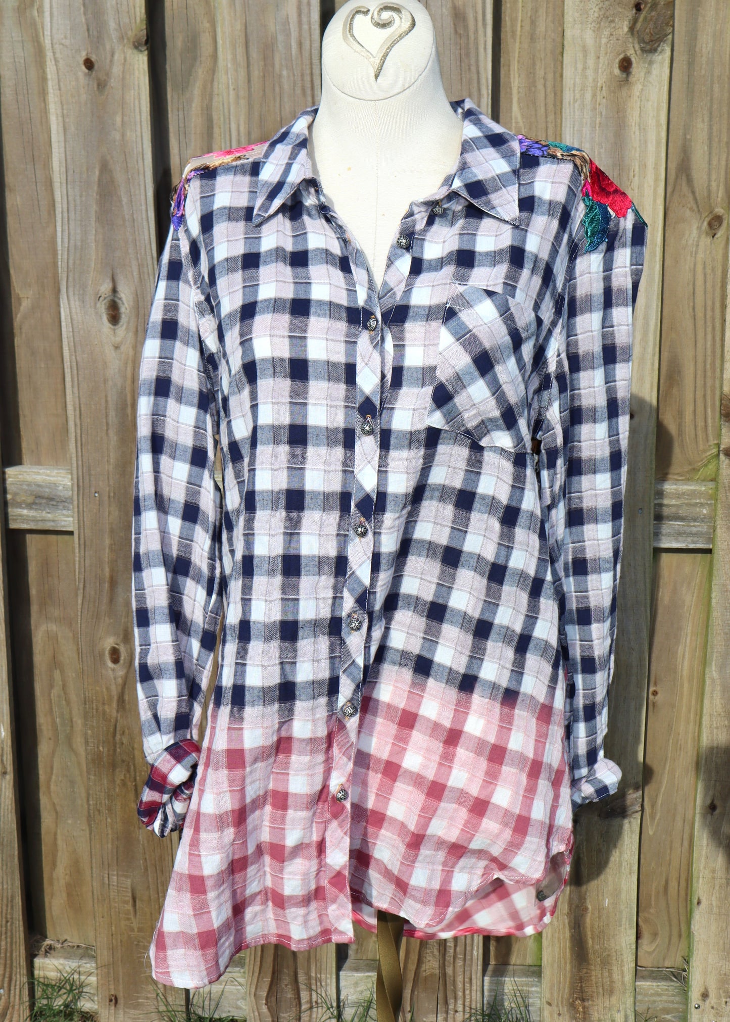 Floral velvet applique-details on a plaid shirt with navy to red ombre effect on mannequin outside