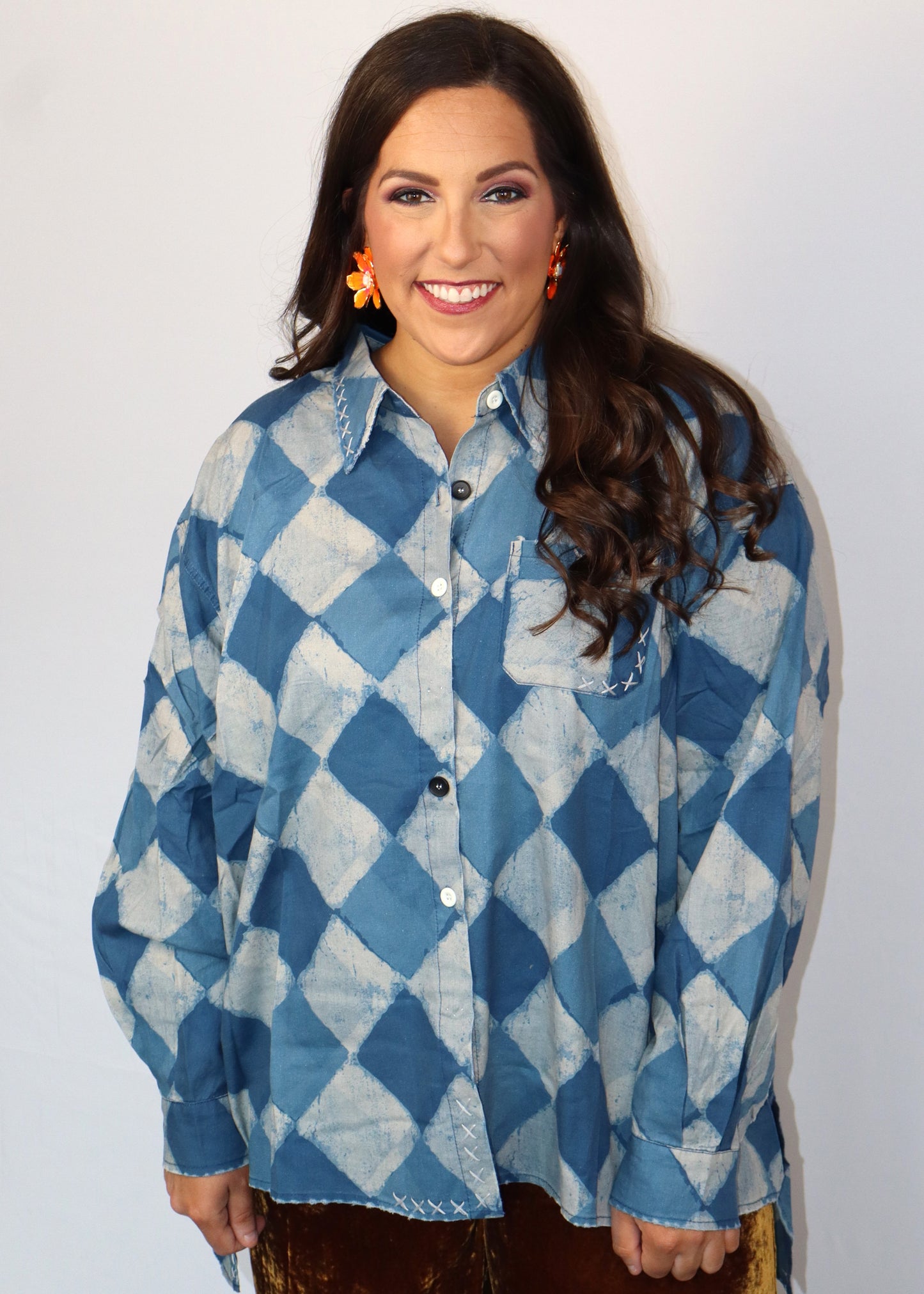 Woman wearing a blue and white checkered shirt against a plain background