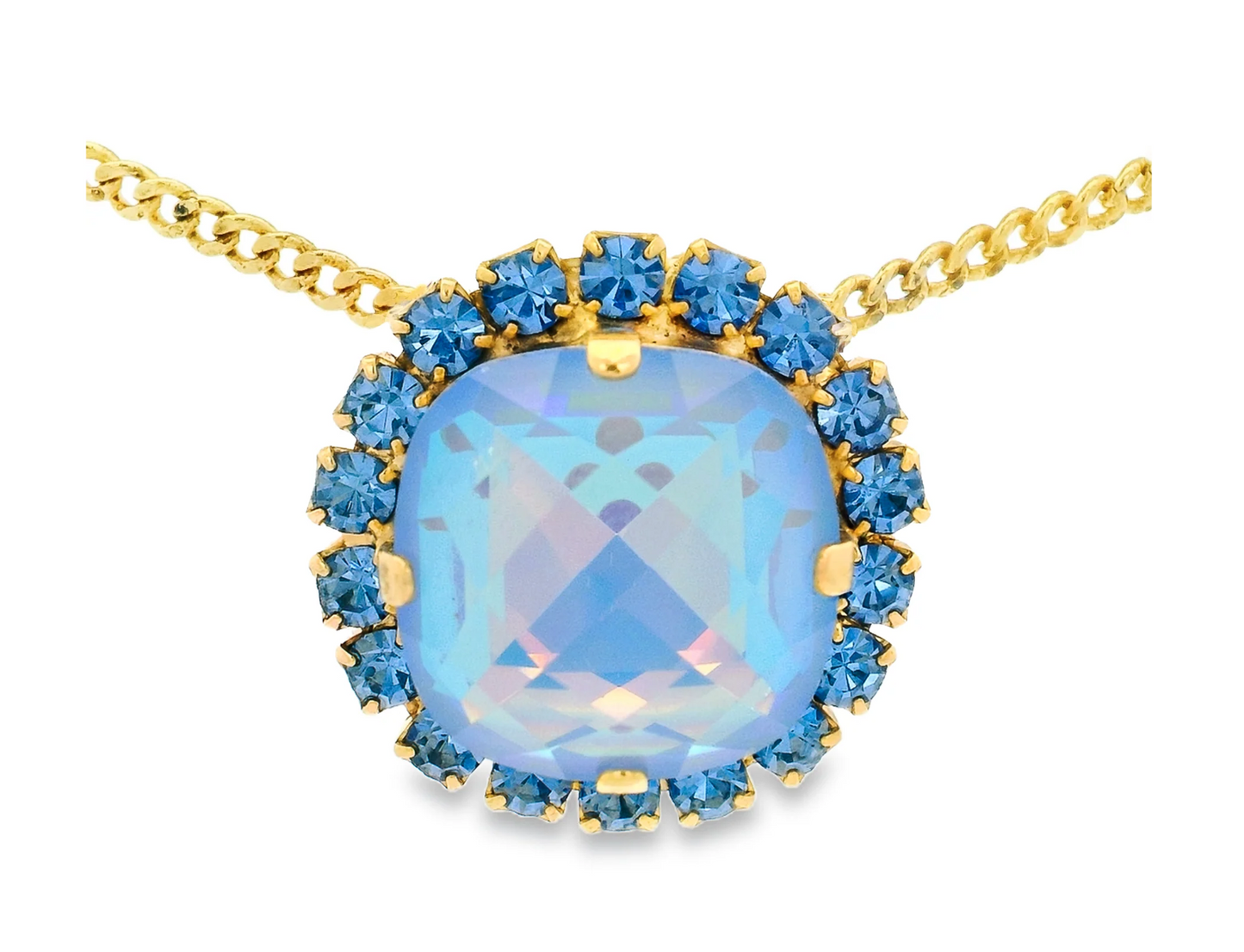Baby blue large Swarovski crystal with blue gemstones on a gold chain against a white background