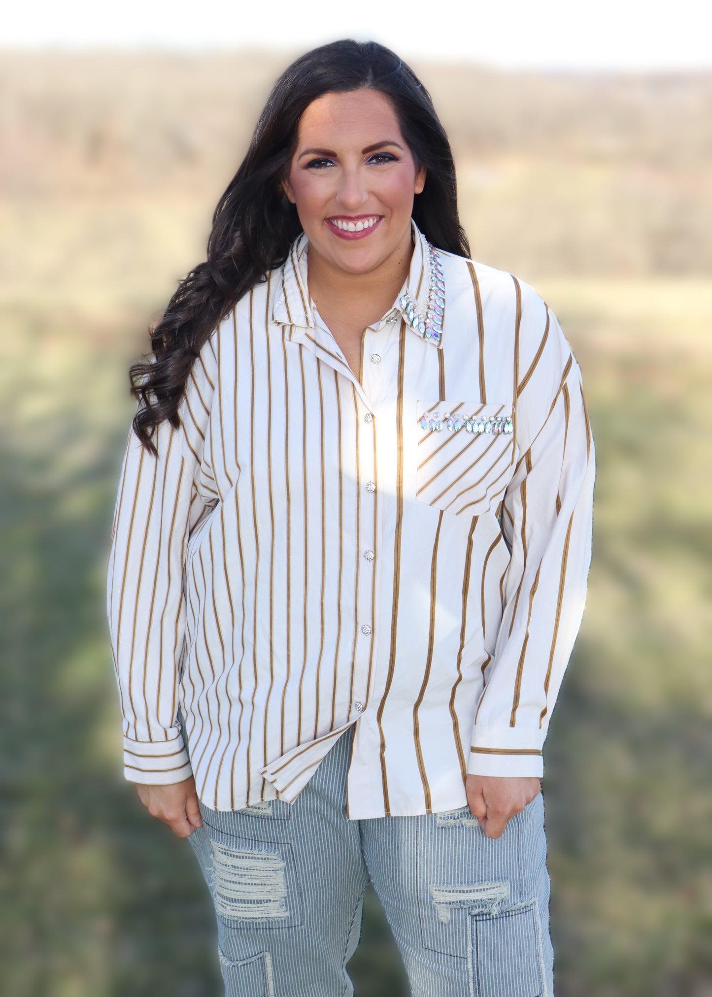 Woman wearing a striped shirt and jeans in an outdoor setting