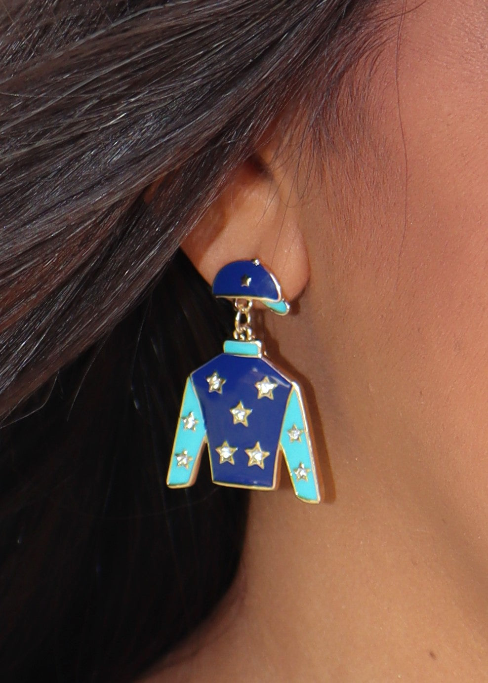 Blue jockey silks earring with stars worn on an ear